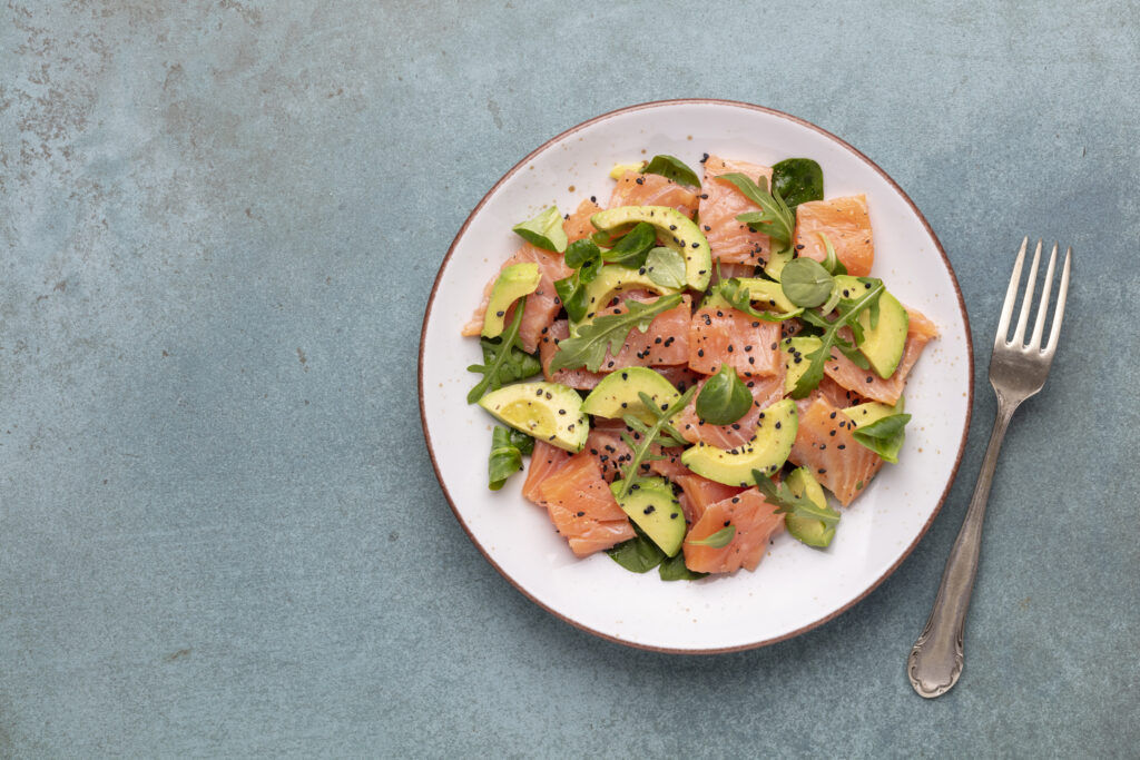 Fresh salmon salad with avocado,  for keto and low carb diet. Ru